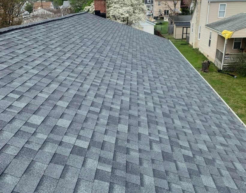 Aerial side angle view of asphalt roofing on a residential home
